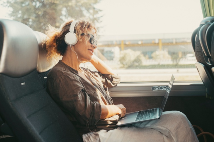 Woman wearing headphones on bus